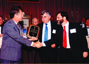 Joseph Lahoud, president of LC Technologies (middle), with Dixon Cleveland of LCT (to his right), accepts an award for Eyegaze technology.