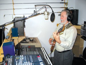 Brian Walker recorded and mixed “Some Plane Music” in his home recording studio north of Divide, Colo. Here, he records some music for his next album. His home recording studio is fully professional.