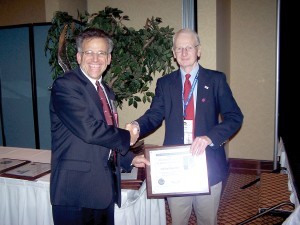 Dean Carswell (right) presents the SSA Henry Combs trophy to Michael Koerner (left) for the greatest number of straight out diamond distance soaring flights.