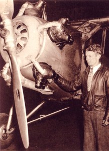 Douglas Corrigan next to the Curtiss Robin at Roosevelt Field in New York in 1938, shortly after completing his nonstop solo flight from Long Beach, California.