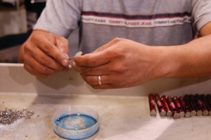 An employee at Reata performs the delicate work of making clips used in fly-fishing for Fishpond, Inc., Silverthorne, Colo.