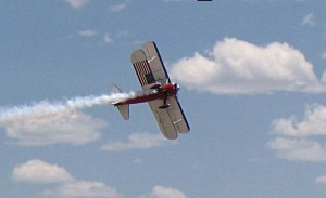 The aerobatic Stearman owned by Greg Shelton displays its patriotic underside as it completes a low altitude roll.