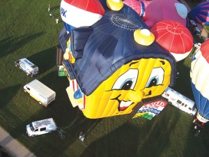 The RE/MAX “Soaring Home” hot air balloon, flown by pilot Russ McLain, gets airborne during the 2005 Rocky Mountain Balloon Festival.