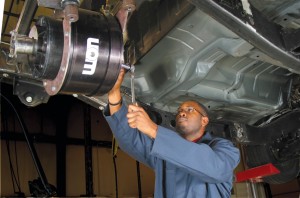 A technician integrates UQM’s 120-kilowatt motor into a Chevy Silverado to meet the needs of a U.S. Air Force contract.