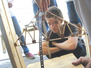 Doug DeVicariis anxiously looks on as his truss design is tested for its weight bearing capabilities.”