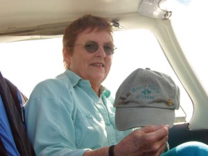 Audrey Wells displays the “Mercy Pilots of Orcas” baseball cap given to her by one of her passengers. On it are her FAA WINGS program, Ninety-nines and AOPA pins.
