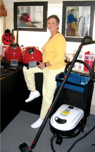 Lady Bug steam cleaners surround Rita Husmann, owner and operator of The Lady Bug Connection.
