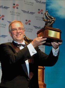 Eclipse Aviation CEO Vern Raburn proudly holds up the 2005 Collier Trophy, which was awarded to Eclipse by the National Aeronautic Association.