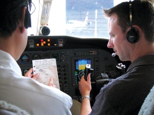 One of JATO Aviation’s seven certified flight instructors (right) reviews procedures with a student pilot prior to takeoff.