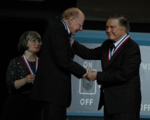 An emotional Cliff Robertson received his award from 1988 enshrinee Bob Hoover, as Janet E. Bednarek looked on.