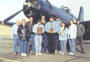 The restoration of Gary Kohs’ FG-1D Corsair won the Grand Champion award at EAA AirVenture Oshkosh in 2003 and a second EAA Golden Wrench award for the restoration crew, shown here with John and Nancy Lane on the left.