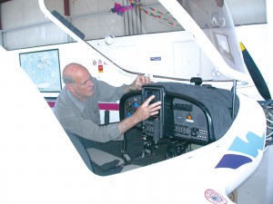 Dave Wheeler, owner of Northwest School of Aviation at Paine Field, checks out the avionics package of flight instruments and GPS system in the new StingSport aircraft he’s using for qualifying sport pilots.