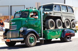 A Fun Run participant shows off his 1930s cab-over-engine Chevrolet truck hauling an eight-wheel Jeep.