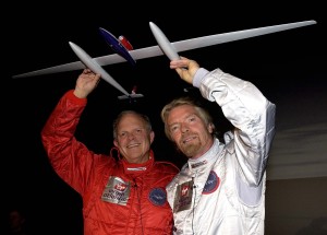 GlobalFlyer sponsor Sir Richard Branson helps Steve Fossett (left) display a model of the record-breaking aircraft.