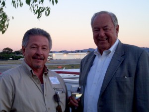 John Sklarski (left), general manager of Syncro Aircraft, and Clay Lacy, Clay Lacy Aviation, visit while enjoying the terrace view at Raytheon’s open house.