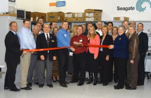 QSE Technologies held an open house in November. Marion Jenkins (left center) and Randy Scott (right center) cut the ribbon at a ceremony commemorating five successful years in business and the grand opening of their new office space.