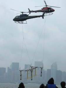 Partnering two helicopters on a single sling load is no small feat. Craig Hosking and his father, Bob Hosking, coordinate the stunt in the black helicopter, while Hosking’s partner, Cliff Fleming, handles the red one.