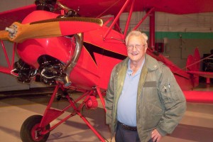 Phil Aune, now retired from 47 years as a VNY tower controller, poses in front of the Fleet biplane flown in the movie.