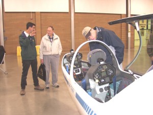William Lynn Weller (left), owner of Northwest Eagle Soaring at Arlington Municipal Airport, talks with a visitor about glider rides and flight instruction.