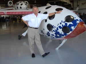 Sir Richard Branson rests his hand on SpaceShipOne, which helped win the Ansari X Prize in October 2004.