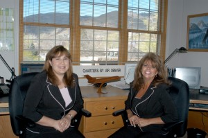 Melissa Berg (left) and Gina DeCarlo, Air Denver charter coordinators, help match customers to more than 3,900 airline and charter companies throughout North America.