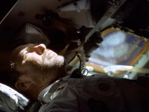 Wally Schirra looks out of the rendezvous window in front of the commander’s station during the Apollo 7 mission.