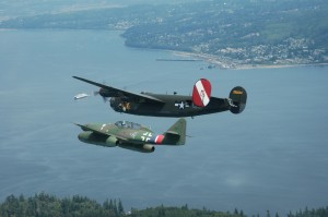 A rare peaceful formation of an Me 262 Stormbird and a B-24 Liberator fly over a Washington ferry and the town of Mukilteo.