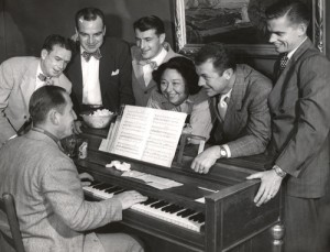 Pancho Barnes was a talented composer of tunes like “Song of the Air Force.” Here she tries out a new song with friends including Chuck Yeager (to her right), at the Happy Bottom Riding Club.