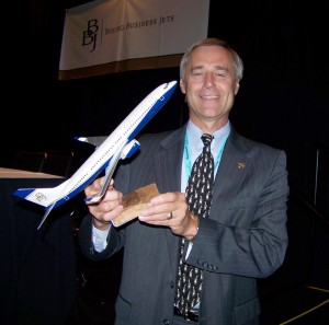 Steven Hill, Boeing Business Jets president, holds a scale model of one of the many Boeing Business Jets. They now include the original BBJ, BBJ 2, BBJ 3, B747-8 VIP and the B787-8 Dreamliner.