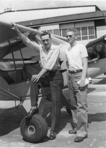 Stan Sears (on the left) and another student take time out from lessons to get their picture taken in front of a Piper J-3 Cub.