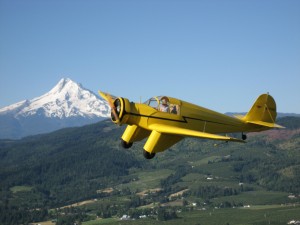 The Western Antique Aeroplane & Automobile Museum’s collection of flying relics includes this rare 1937 Aeronca LC, passing by Oregon’s Mount Hood.