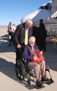 Mayor Hawker assists a passenger into the Phoenix-Mesa Gateway Airport terminal after her arrival from Cedar Rapids.