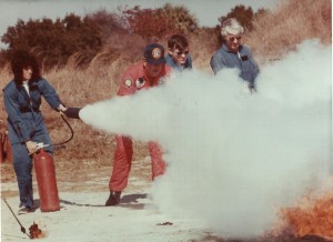 Astronaut Judith Resnik extinguishes a fire as part of her emergency training. Resnik, who perished aboard Challenger in 1986, held a doctorate in mathematics.