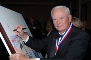 Barron Hilton signs the art board during the 5th annual Living Legends of Aviation.