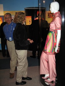 Displayed in the exhibit is a colorful Braniff Airlines uniform from the late 1960s. Designers who added to the haute couture of the day included Parisian Jean Louis, Italian Emilio Pucci and artist/designer Mario Armond Zamparelli.