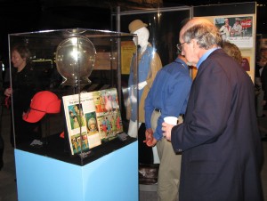 A visitor reads about the now-rare helmet hat from the Braniff Airlines flight attendant uniform of the 1960s. Pastels were popular then, but styles would evolve into daring uniforms.