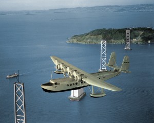 During the departure of the first survey flight on April 16, 1935, San Francisco Bay–Honolulu, a Sikorsky S-42 flies over the pylons of the yet to be completed San Francisco-Oakland Bay Bridge.