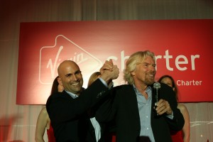 Richard Branson, clasping the hand of Scott Duffy, Virgin Charter CEO and founder, said Virgin’s “brilliant customer service and aviation expertise combined with unprecedented technology prowess has resulted in a winning formula.”