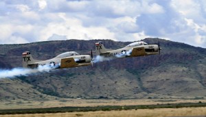 Backed by the Davis Mountains, two Raytheon T-34 Air Force training aircraft fly over the 2007 Big Bend Air Show.