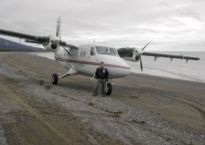 Chris Sis poses with an Era Aviation Twin Otter at Cook Inlet. The photo isn’t crooked—imagine landing at such an angle!
