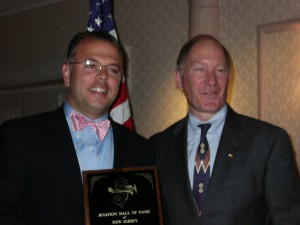 Attorney Will Mennen, left, accepted the inductee plaque on behalf of his late grandfather, George Mennen.