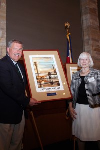 Centennial Airport Director Robert Olislagers presents an award to Dr. Gwen Mayo, honoring her years of pioneering work and commitment to aviation.