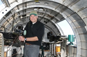 Barry Bills "operates" one of the two waist gunner turrets on the B-17.