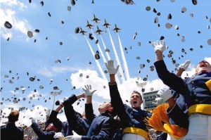 Hats fly as the U.S. Air Force Thunderbirds roar overhead at the moment of graduation.
