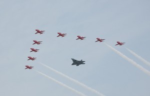 Maj. Paul Moga flies in formation in an F-22 Raptor with the Royal Air Force Aerobatic Team, the Red Arrows.