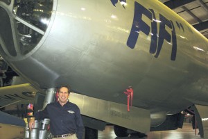 CAF president and CEO Steve Brown poses in front of the nose gear of Fifi in the CAF restoration hangar.