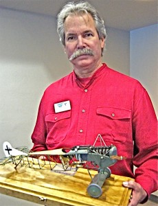 Steve Anderson holds his prize-winning model of a Fokker D.1, which depicts the construction of the aircraft and has a tiny, but remarkably detailed, engine.
