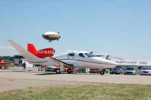 The Goodyear blimp returned for a second straight appearance. It flew orbits around the field and anchored at Pioneer Airport. The Eclipse 400 jet is in the foreground.
