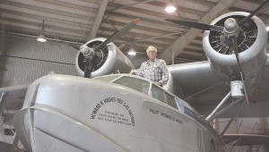 Jesse Bootenhoff, current caretaker of the S-43, stands inside the cockpit of the historic airplane.